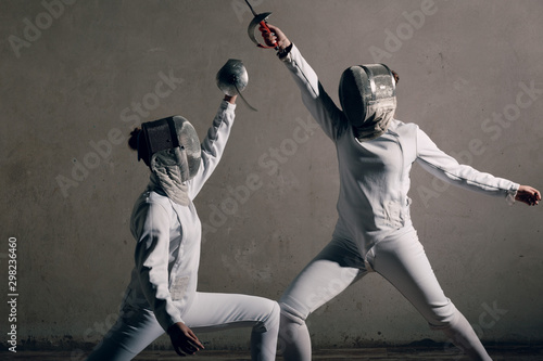 Fencer women with fencing sword.