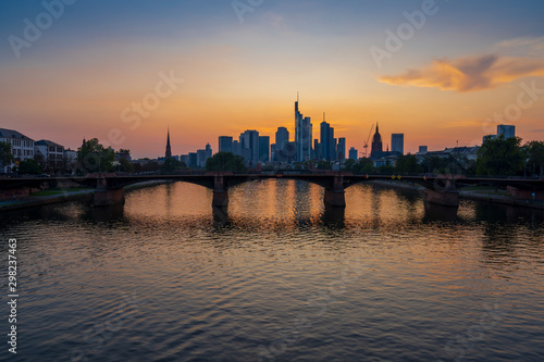 Frankfurt skyline and Alte Brucke bridge over river main at dusk