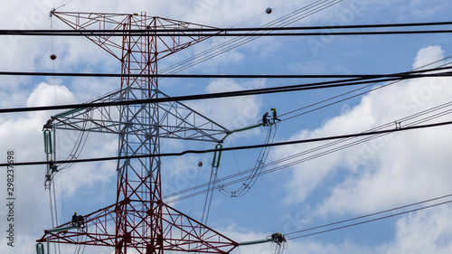 Electrician work installation of high voltage cable in high voltage safely and systematically over and blue sky background. photo