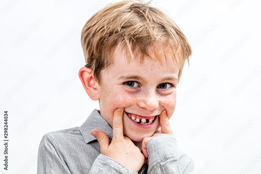 adorable boy playing with a fake toothless smile, isolated portrait adorable boy playing with a fake toothless smile, isolated portrait