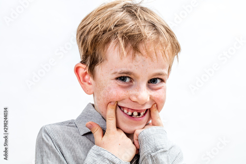 Fototapeta adorable boy playing with a fake toothless smile, isolated portrait