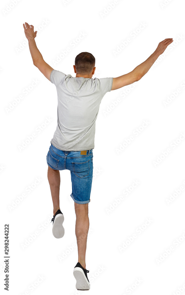 Side view of a man dancing in shorts.