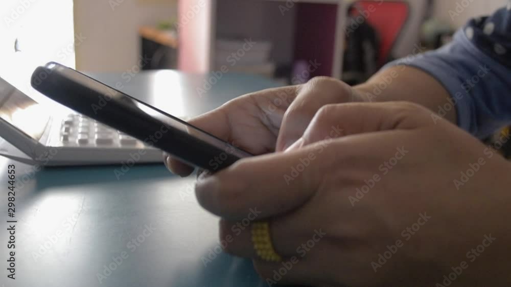 Woman using smart phone on the desk at home, Typing text message on cell phone. Woman using smart phone on the desk at home, Typing text message on cell phone.
