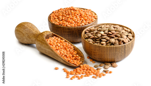 Lentils in a wooden bowls and scoop isolated on white background. Full depth of field