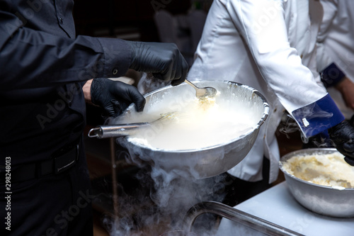 Chef is cooking ice cream with liquid nitrogen