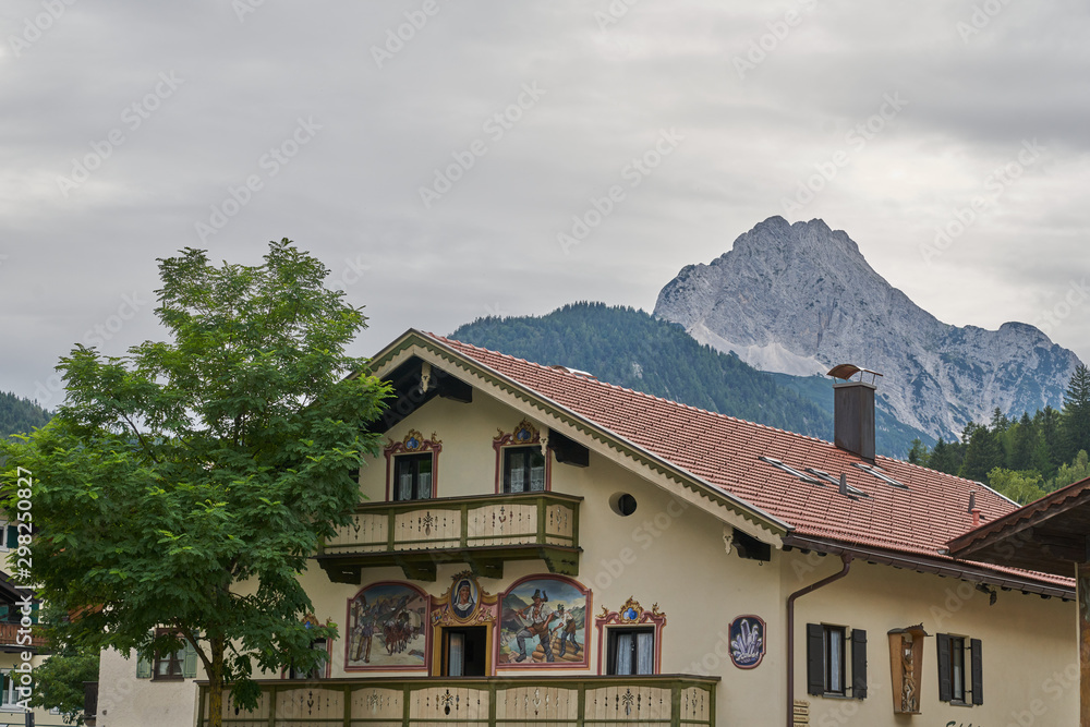 A typical German house with mountains in the same frame
