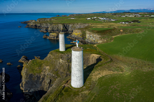 Aerial view, The Metal Man is a 3-metre tall cast-metal figure of a sailor pointing seawards. According to local lore, he is said to warn seafarers away from dangerous shallow waters.