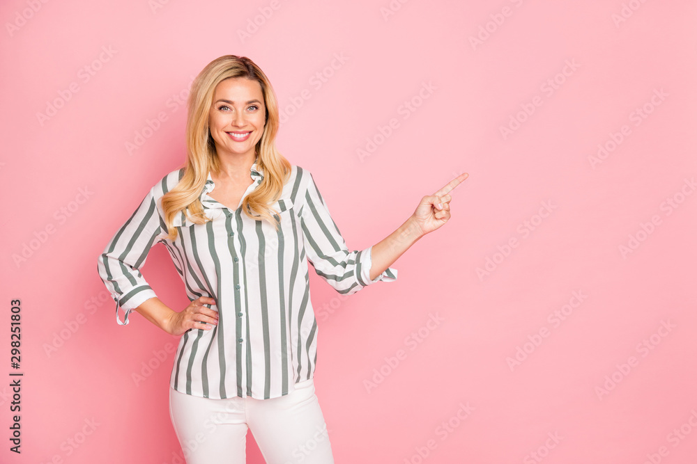 Photo of cheerful white cute nice attractive woman pointing at empty space to be filled with advertisiment smiling toothily isolated over pastel color background in trousers pants - obrazy, fototapety, plakaty 
