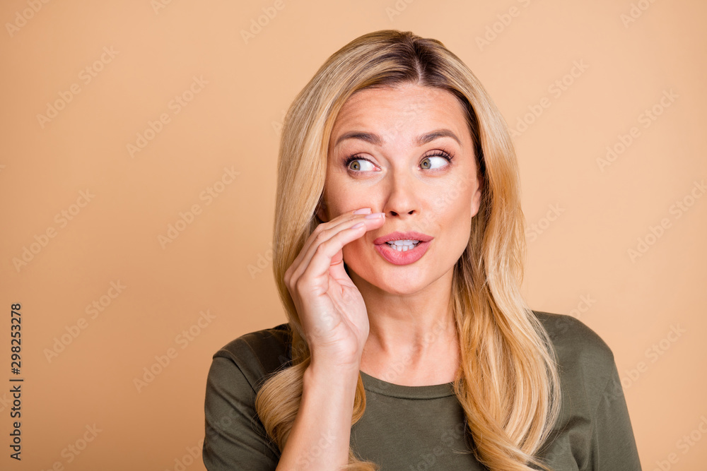 Close up photo of suspecting woman whispering you secret green information isolated beige pastel color background Close up photo of suspecting woman whispering you secret green information isolated beige pastel color background