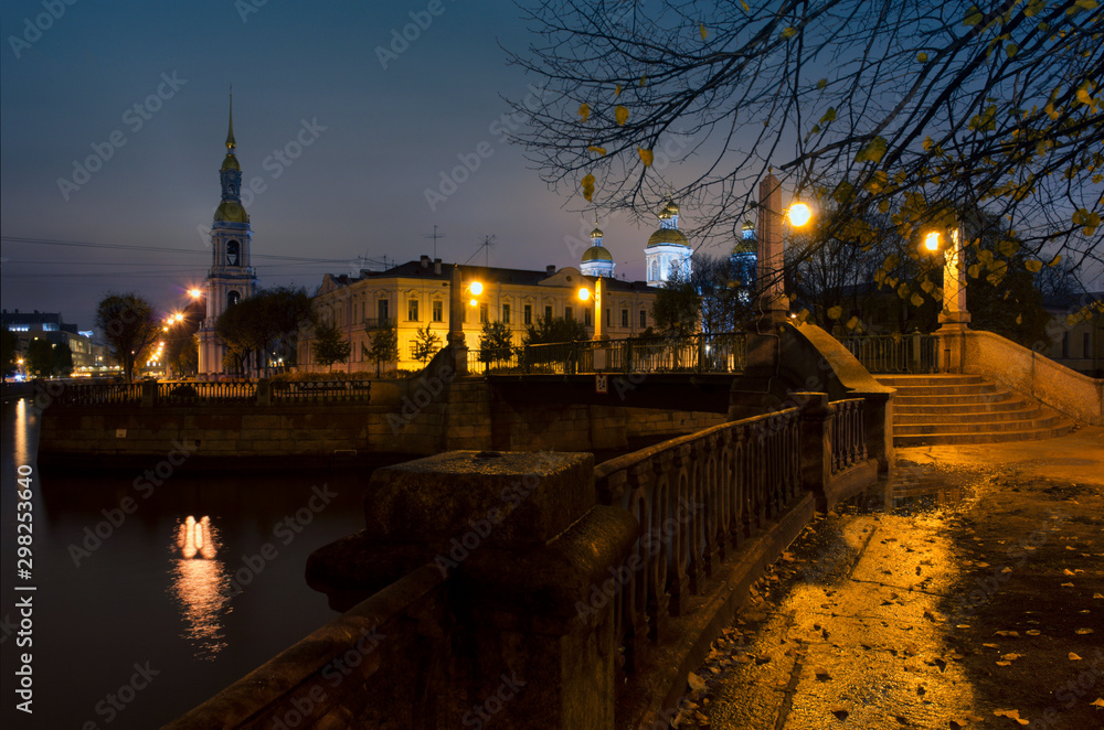 Night autumn landscape with St. Nicholas Naval Cathedral and and the bell tower and the granite embankment (Saint Petersburg, Russia)