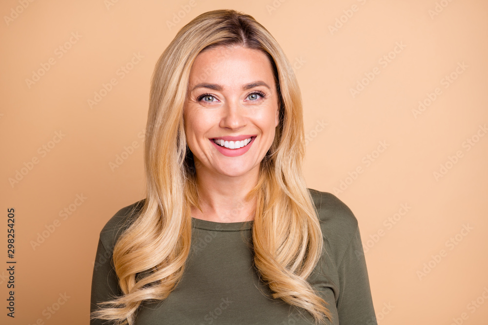 © deagreez - Portrait of cheerful cute nice pretty mature woman looking good smiling in green cheerfully isolated pastel beige color background © deagreez - Portrait of cheerful cute nice pretty mature woman looking good smiling in green cheerfully isolated pastel beige color background