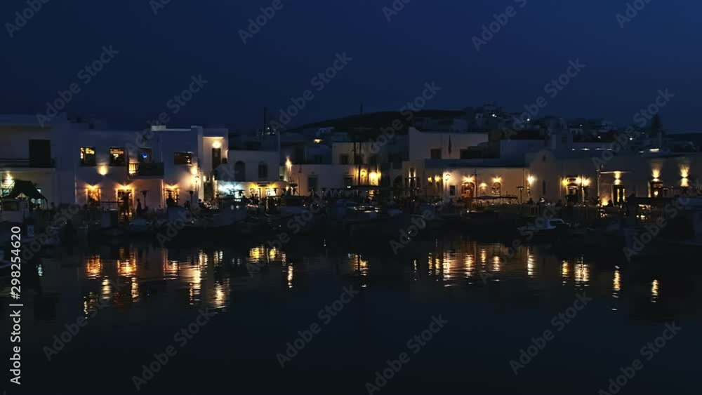 Night view of harbor, restaurants and people in Naoussa, Paros, Greece Night view of harbor, restaurants and people in Naoussa, Paros, Greece