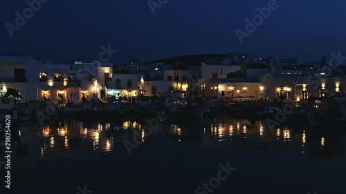 Night view of harbor, restaurants and people in Naoussa, Paros, Greece