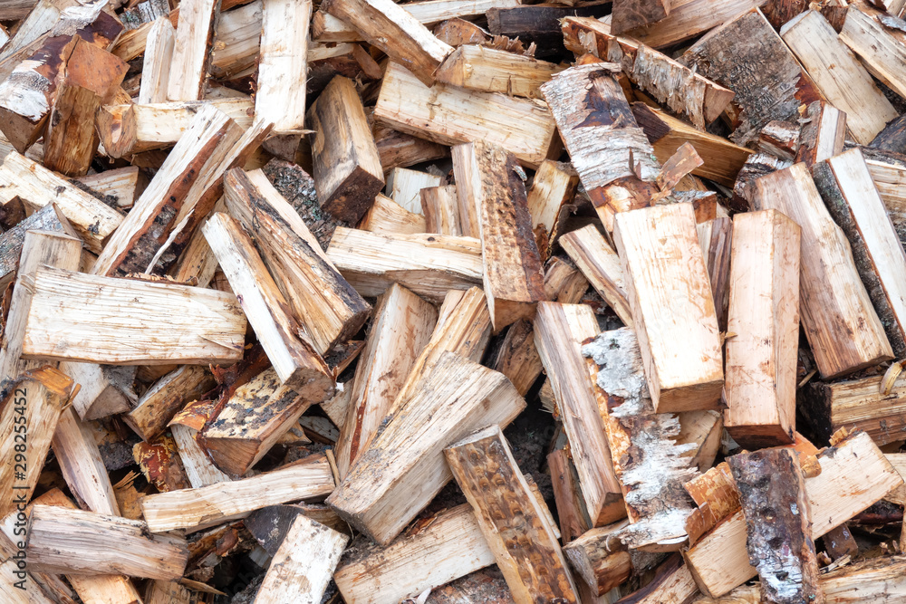 Messed up birch firewood. Fragment of a large pile of logs. Billet for winter use in the oven. Background. Texture. Messed up birch firewood. Fragment of a large pile of logs. Billet for winter use in the oven. Background. Texture.