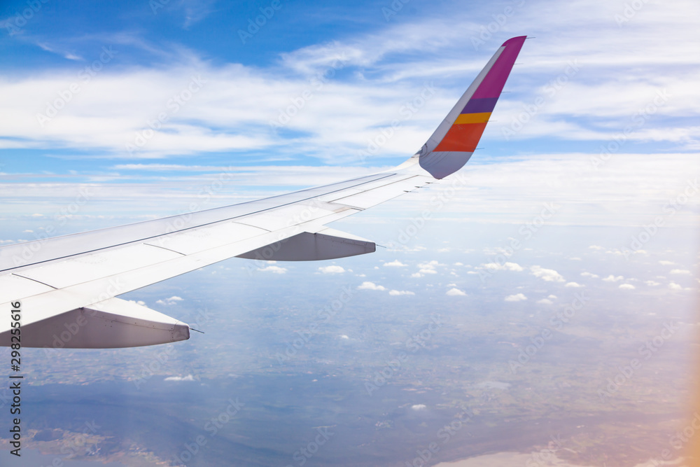 Fototapeta premium Aircraft Wing on blue sky and white clouds background.