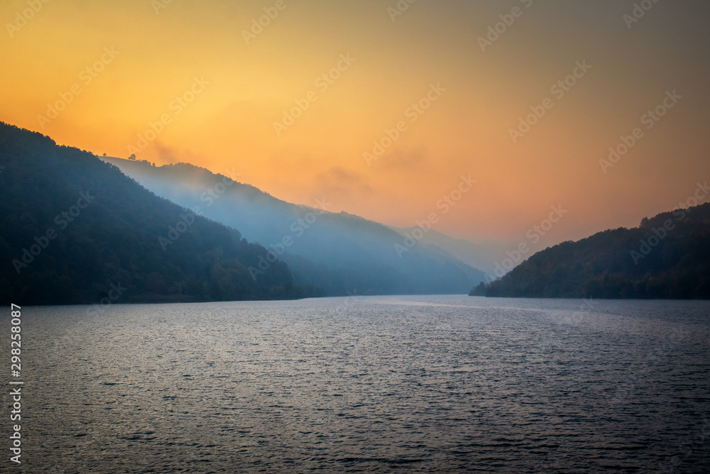 Autumn morning on the river surrounded by mountains. Danube river in Djerdap national park in Serbia on Romanian Border. Autumn morning on the river surrounded by mountains. Danube river in Djerdap national park in Serbia on Romanian Border.