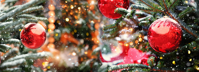 christmas and new year holidays concept. Red balls on fir branches, winter snowy backdrop. festive winter season background. template for design. banner, copy space