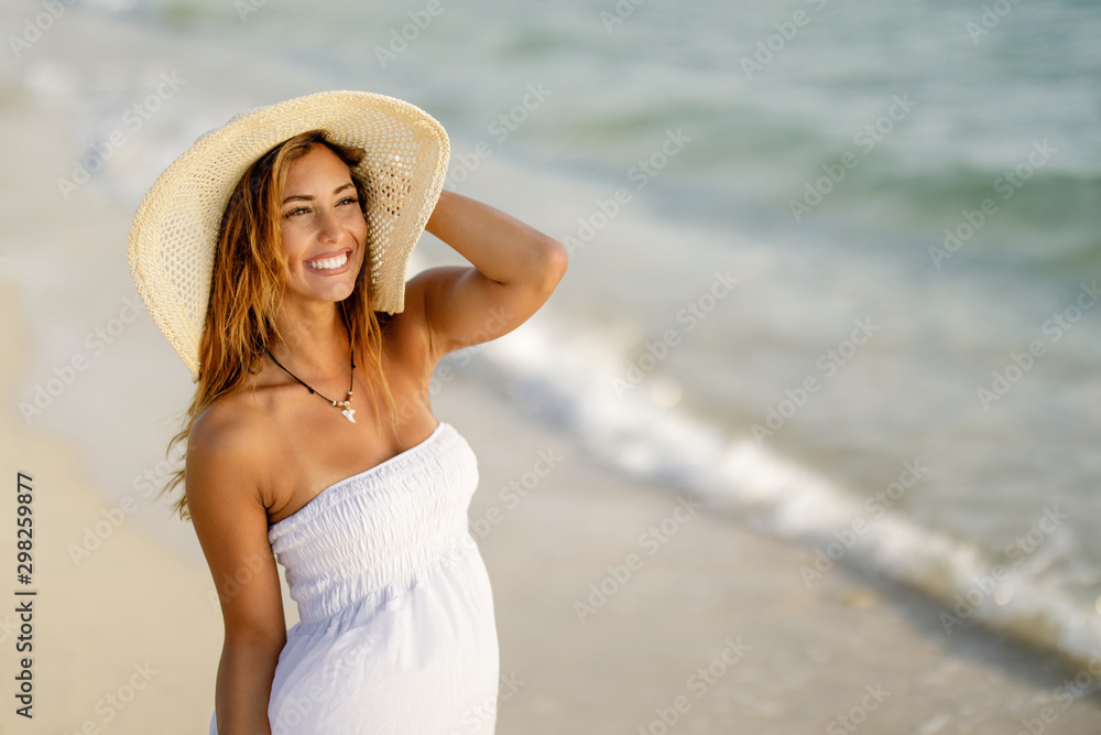 Beautiful woman enjoying in summer day at the beach.