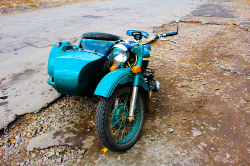 Fototapeta Naklejka Na Ścianę i Meble -  A motorcycle with a sidecar stands on the road