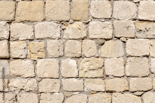 The background old beige wall made of natural stone