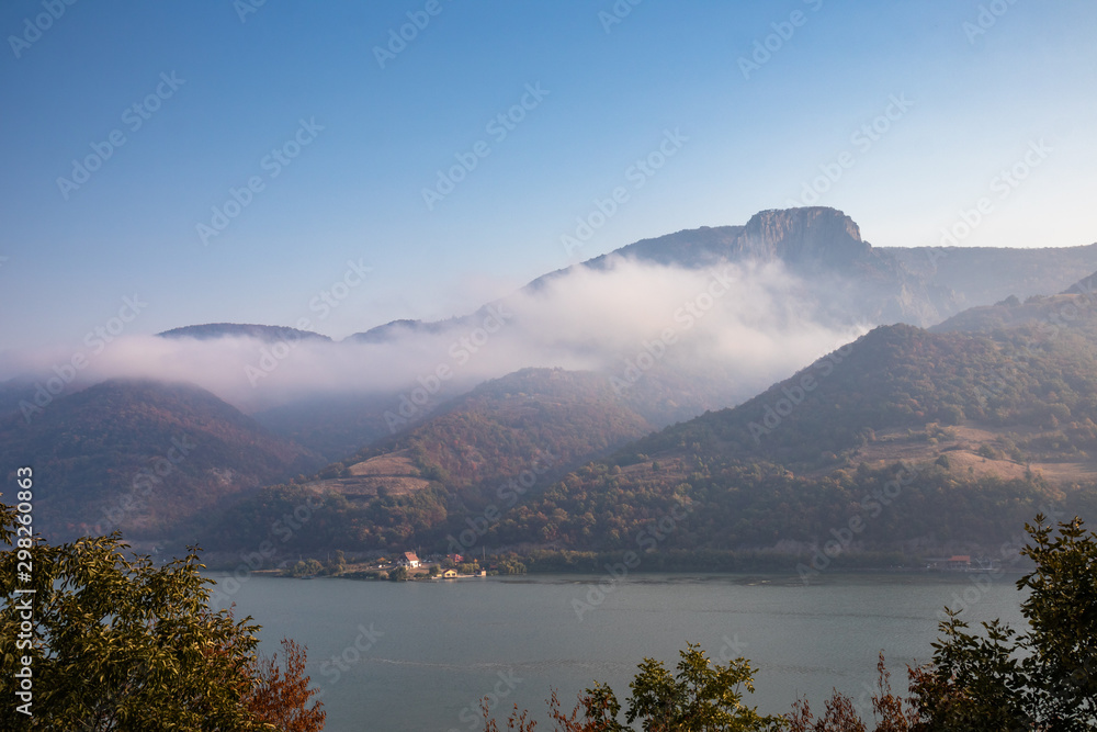 Autumn morning on the river surrounded by mountains. Danube river in Djerdap national park in Serbia on Romanian Border.