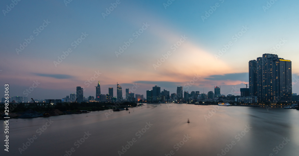 Aerial view of Saigon Cityscape at Sunset Boats And Ship cross the river golden hour