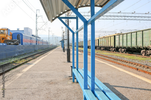 Freight train on the platform. Rail Cargo transit.