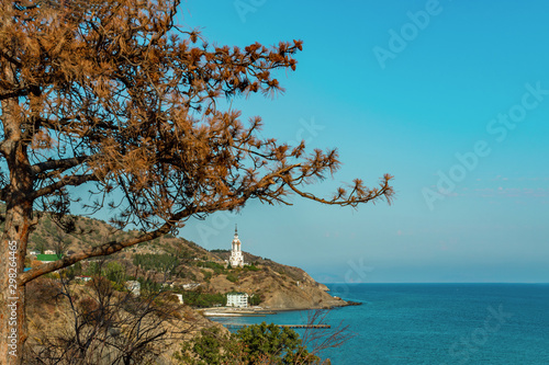 Temple lighthouse in honor of St. Nicholas on the seashore. Monument to the dead on the waters photo