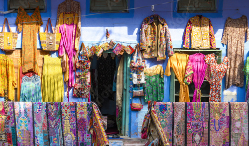 Wallpaper Mural Stunning view of colorful clothes, bags and patchwork hanging outside a small shop on the streets of the blue city of Jodhpur during the Diwali (Deepvali or Dipvali) festival. Rajasthan, India. Torontodigital.ca