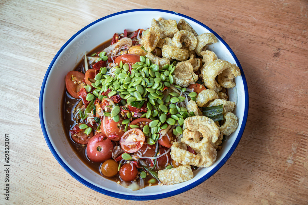 Papaya salad with crispy pork is a popular trays in Thailand.spicy food call name Som-Tum-Poo-Pla-Ra. Papaya salad with crispy pork is a popular trays in Thailand.spicy food call name Som-Tum-Poo-Pla-Ra.
