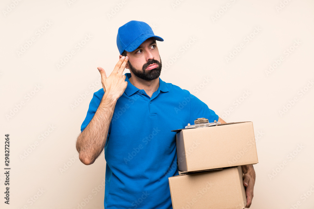 Delivery man with beard over isolated background with problems making suicide gesture Delivery man with beard over isolated background with problems making suicide gesture