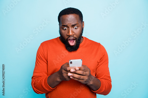 Photo of casual nice mixed-race handsome man having been disappointed with feednews feedback received from subscribers being about to cry isolated vivid color blue background photo