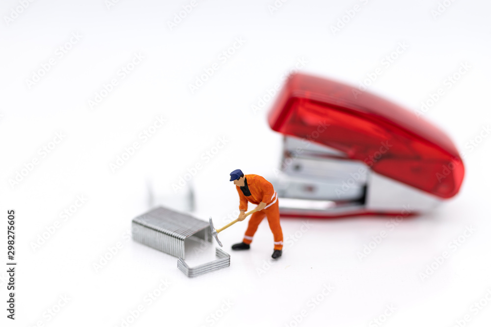 Miniature people : Employee with stapler, image use for office equipment Miniature people : Employee with stapler, image use for office equipment