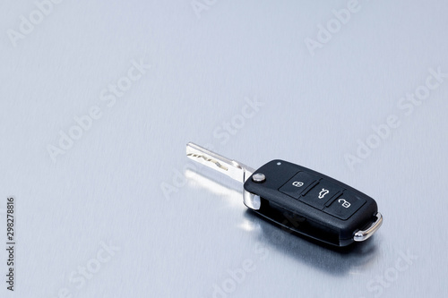 New remote vehicle key fob on aluminium background. Repair of broken or damaged remote key fob of any vehicle car service.- Image