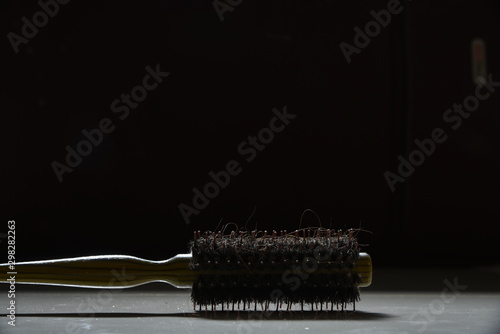 BRUSH YOUR HAIR ,PLACE IT ON THE FLOOR IN THE DARK BACKGROUND ATMOSPHERE
