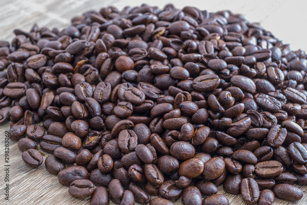 Coffee beans on wooden background with copyspace left. Coffee beans on wooden background with copyspace left.