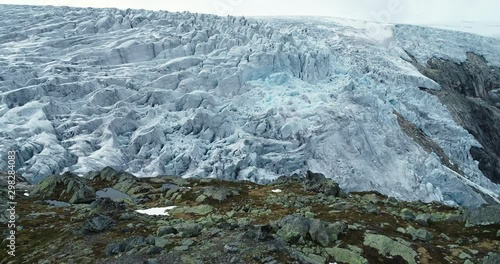 Folgefonna glacier hides itself behind rocky mountain. Norway. Ice cap. photo