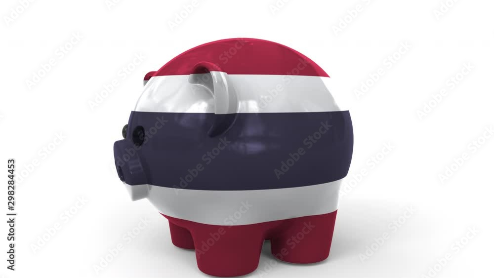 Coins fall into piggy bank painted with flag of Thailand. National banking system or savings related conceptual 3D animation Coins fall into piggy bank painted with flag of Thailand. National banking system or savings related conceptual 3D animation