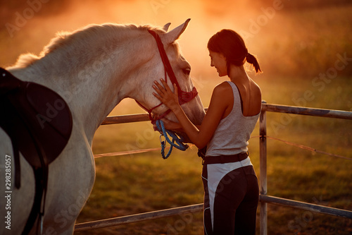 Girl with hourse. Woman and her horse on a sunset.