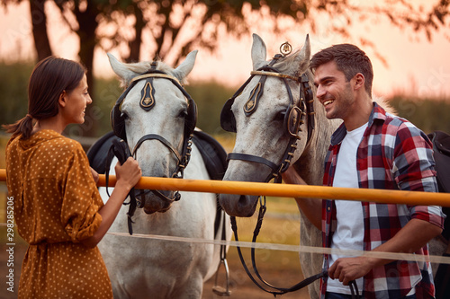  Smiling girl and man with their horse in evening sunset © luckybusiness