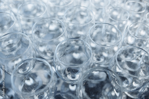 Close-up photo of empty glasses on the banquet table in natural light.