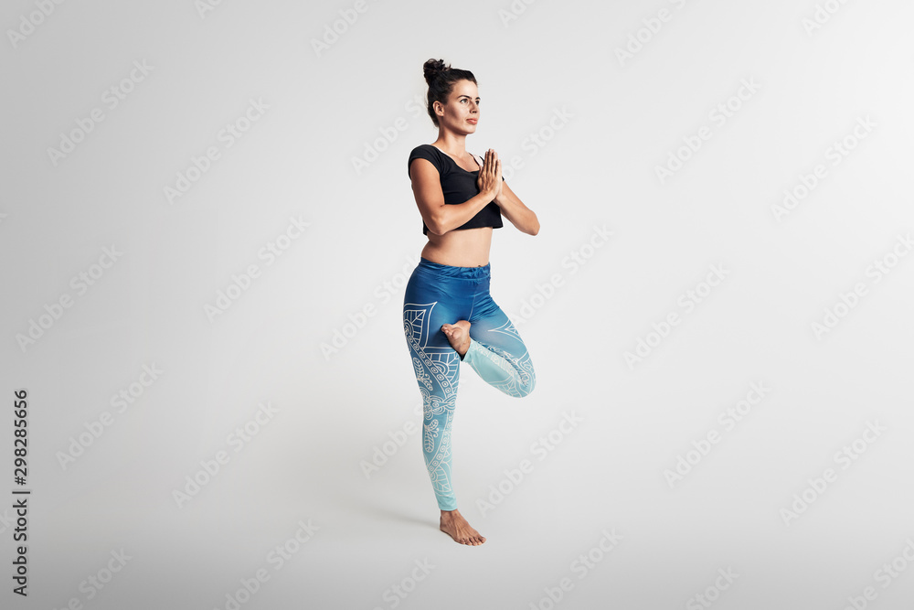 Tree pose, yoga pose, woman on white background