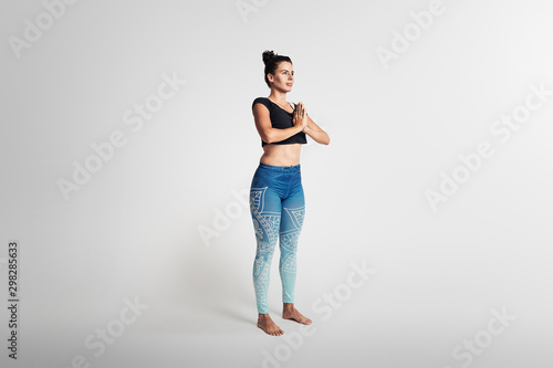 mountain pose, yoga pose, woman on white background © JiriLizler