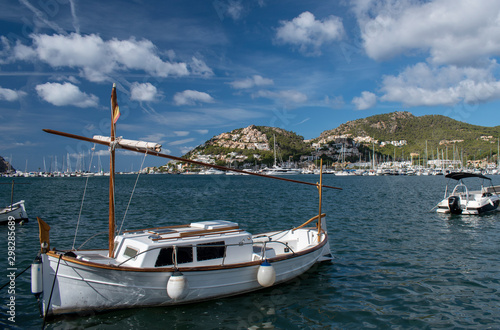 Port d'Andratx Mallorca, view of a small sailing boat in the foreground with the main marina area in the background, on a warm and beautiful day in Autumn.