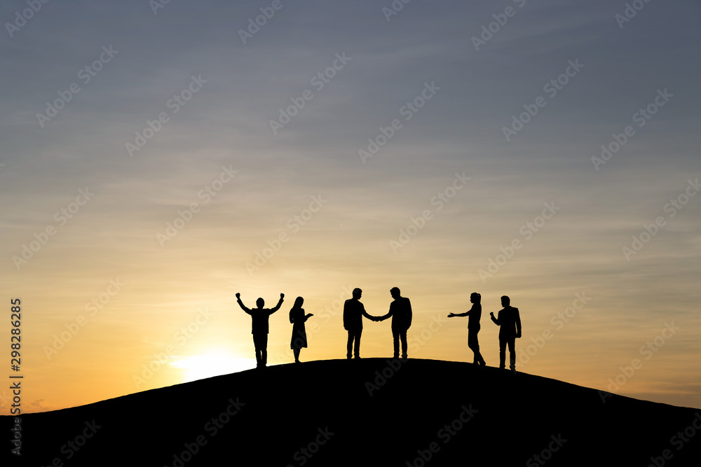 Silhouette group of business people are celebrating success at sunlight background. Business and goal concept.