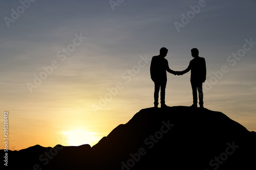 Silhouette of businessman are celebrating success at sunlight background. Business and goal concept.