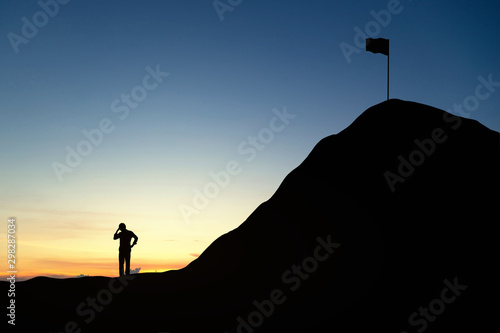 Silhouette man are sad to not be able to climb the mountain. Sky and sunset background. Unsuccessful and fail concept.