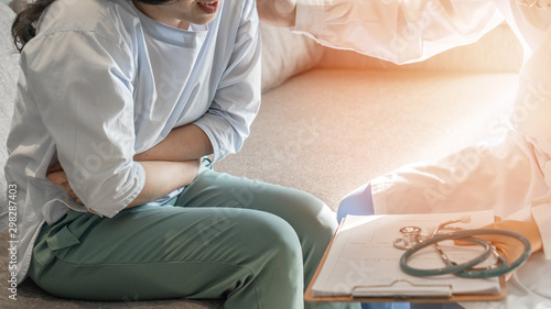 Картината върху платно Abdominal pain patient woman having medical exam with doctor on illness from sto