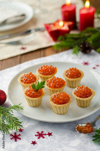 tartlets with red caviar on festive table