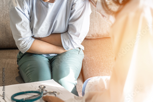 Abdominal pain patient woman having medical exam with doctor on illness from stomach cancer, irritable bowel syndrome, pelvic discomfort, Indigestion, Diarrhea, GERD (gastro-esophageal reflux disease)
